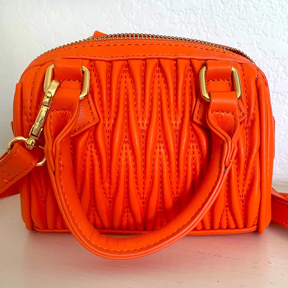 Mini orange purse with long removable strap